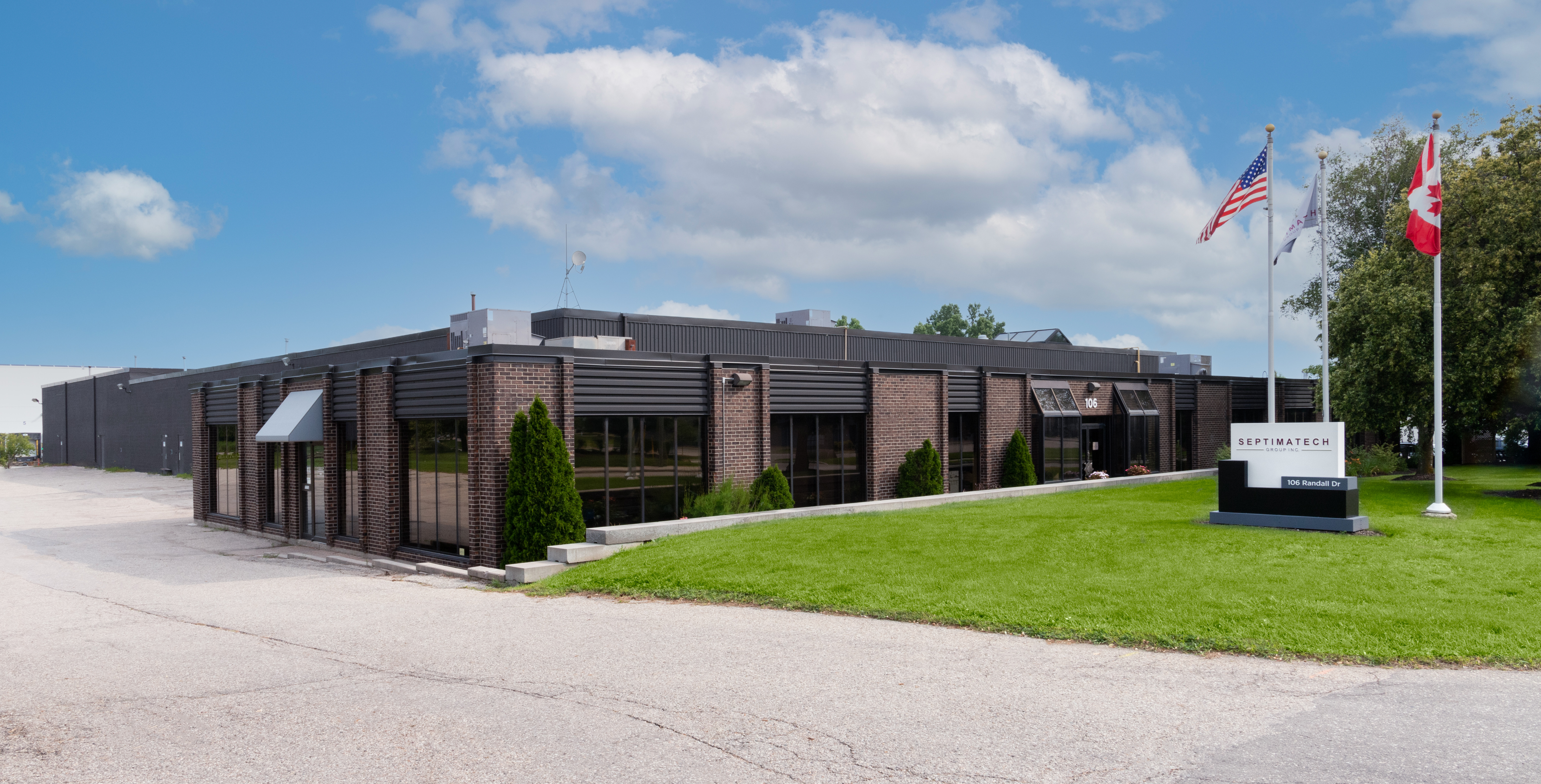 The Septimatech office building with a tree and sign out front.