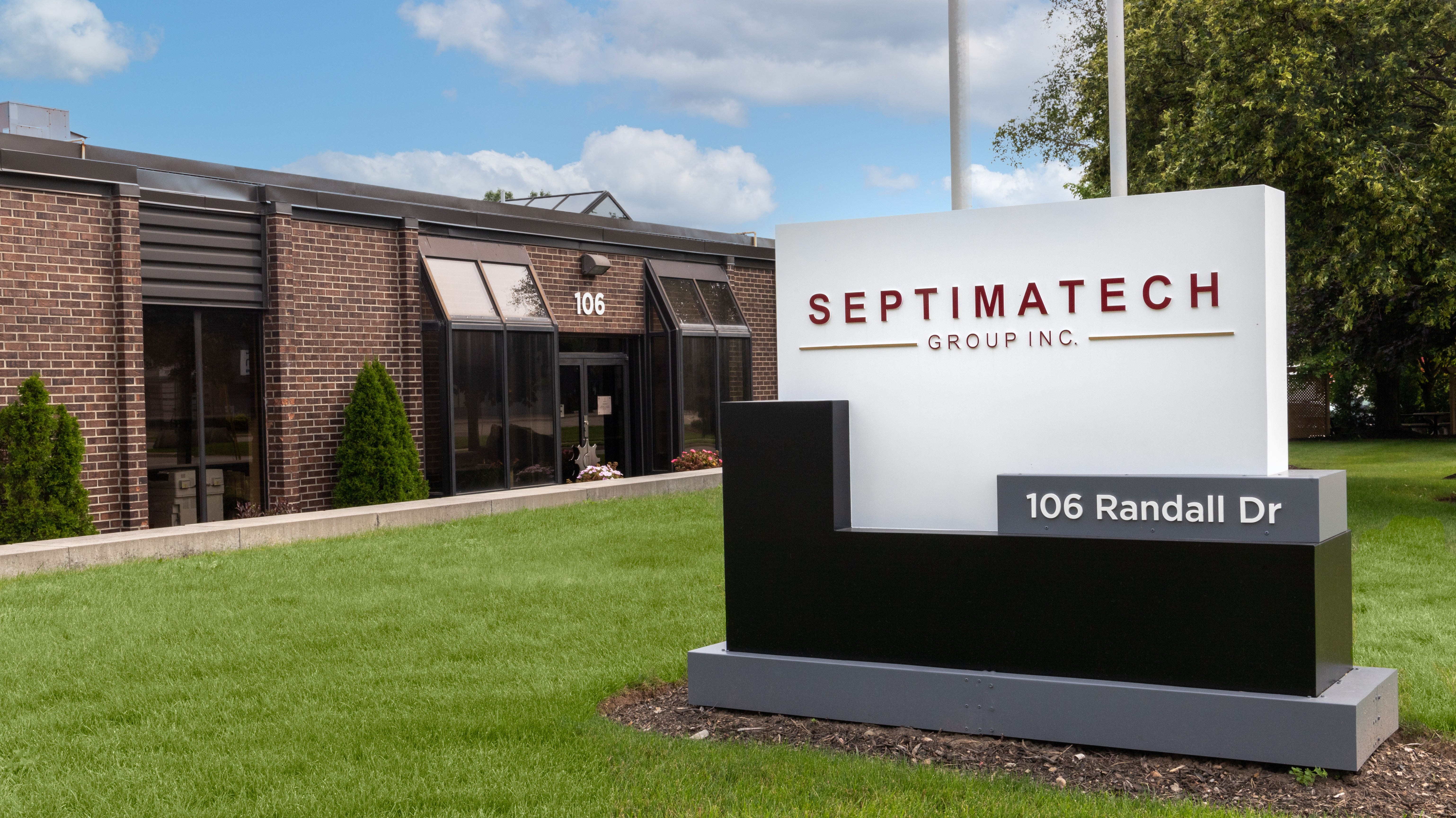 Septimatech's office sign at the front of a building